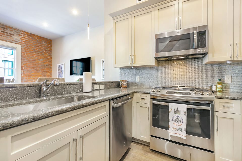 Cook and dine easily in the fully stocked kitchen, equipped with all stainless steel appliances, gas range, basic cookware, and a dining area for a comfortable meal at home. Entertain at the bar with seating for four.