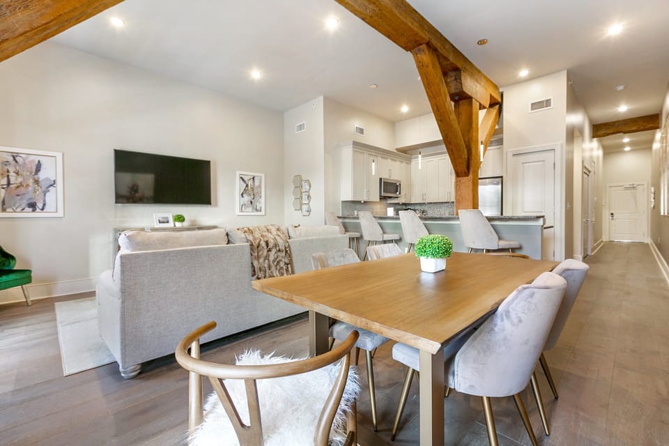 Open-concept living, kitchen, and dining area with plenty of seating. Enjoy a 65” Samsung Smart 4K TV with streaming and DIRECTV Entertainment. Dining table for four and lots of natural light!