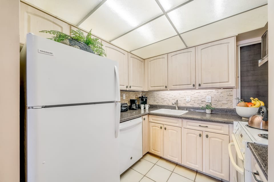 Enjoy cooking at your fully furnished kitchen with white  appliances