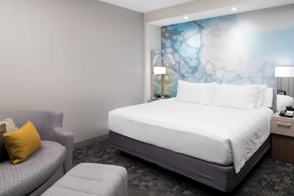 Premium bedding, desk, laptop workspace, blackout drapes