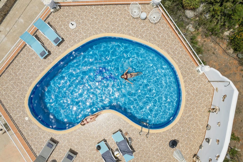 The luxurious pool area with sunbeds, parasols and pool shower!