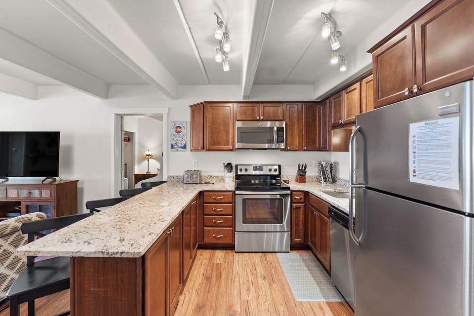 Prepare memorable meals in your spacious kitchen featuring granite counters, stainless appliances, and rich wood cabinets.
