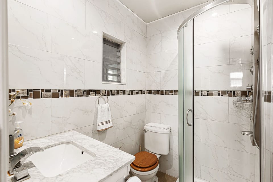 Master bathroom, with full body shower!  Enjoy after a day on the beach!