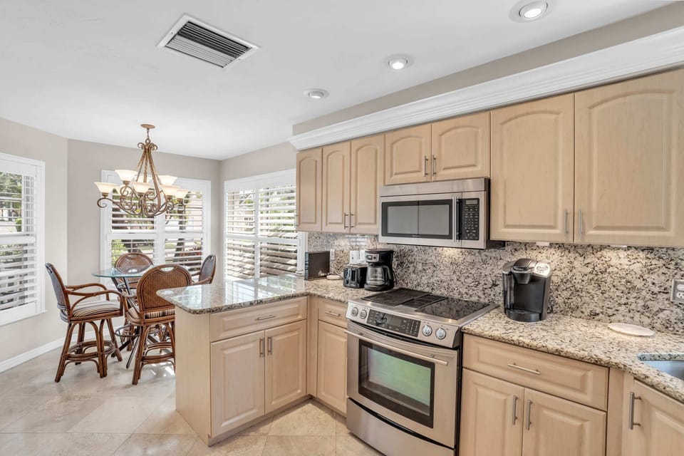 The Kitchen is Spacious and Has Granite Counter and Stainless Steel Appliances