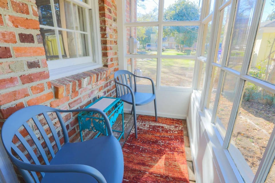 The small sunroom has a seating area for two.