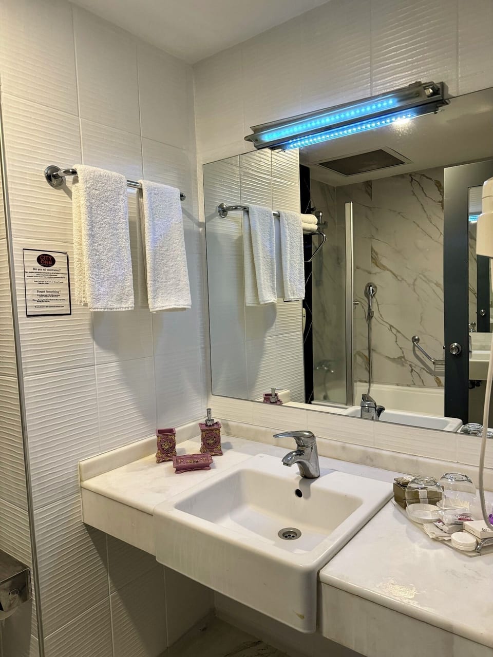 Bathtub, hair dryer, slippers, towels