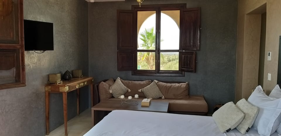 Luxury Suite | Living area | 55-cm TV with satellite channels