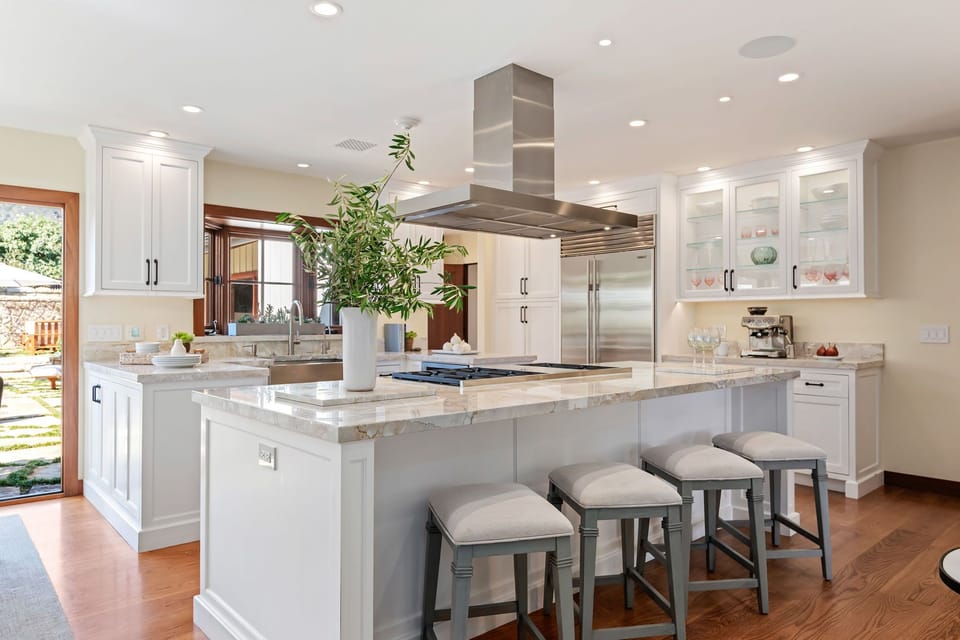 The kitchen "wows" with a great island and backyard pool views