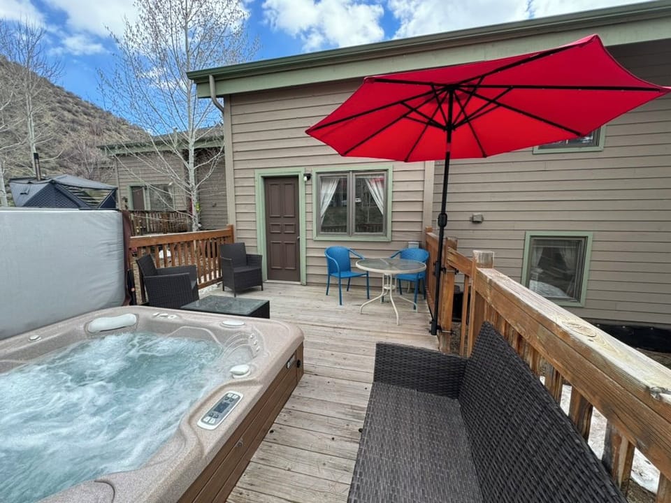 Hot tub and deck seating with mountain views