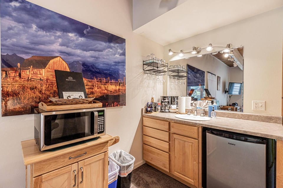 Convenient kitchenette with mini fridge, microwave, coffee station, and all the essentials for a comfortable stay.