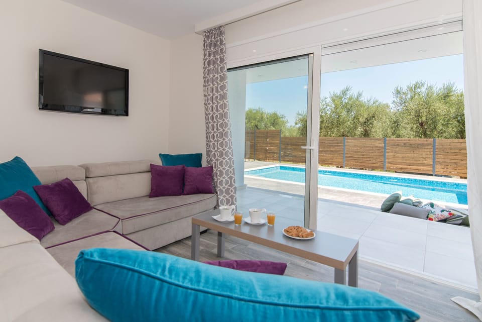 Family Villa | Living area | 32-inch flat-screen TV with satellite channels, TV
