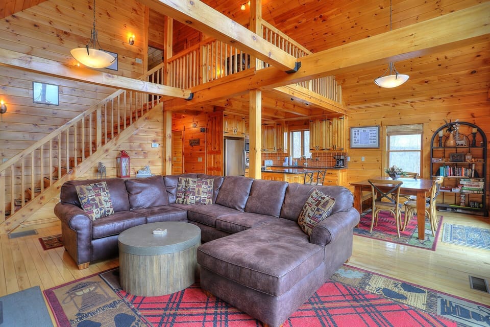 Living Room - view of stairs to upper level and loft, kitchen, and dining area