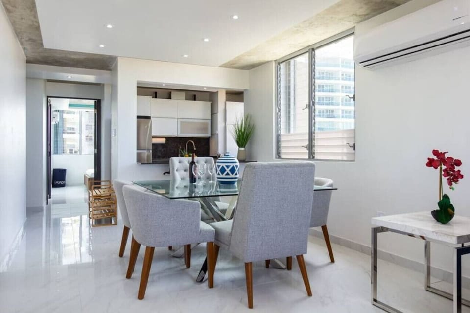Glass top square dining room table where 6 people can eat comfortably.