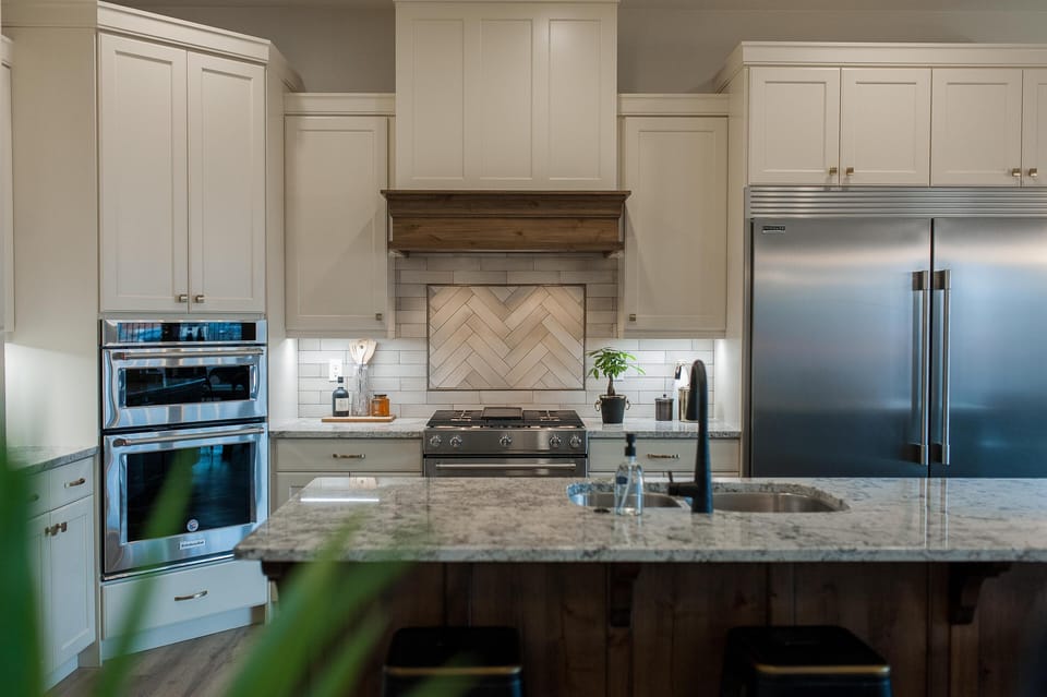 Grand kitchen features a sub-zero style refrigerator, gas range, oven, icemaker