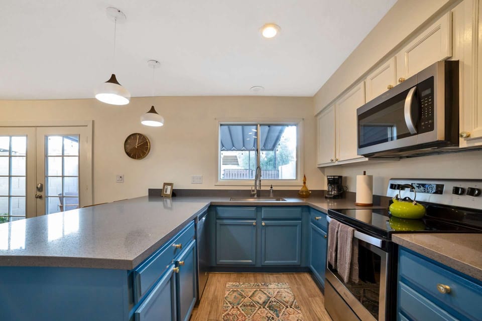 Kitchen with microwave, stove/oven, fridge, dishwasher, utensils etc