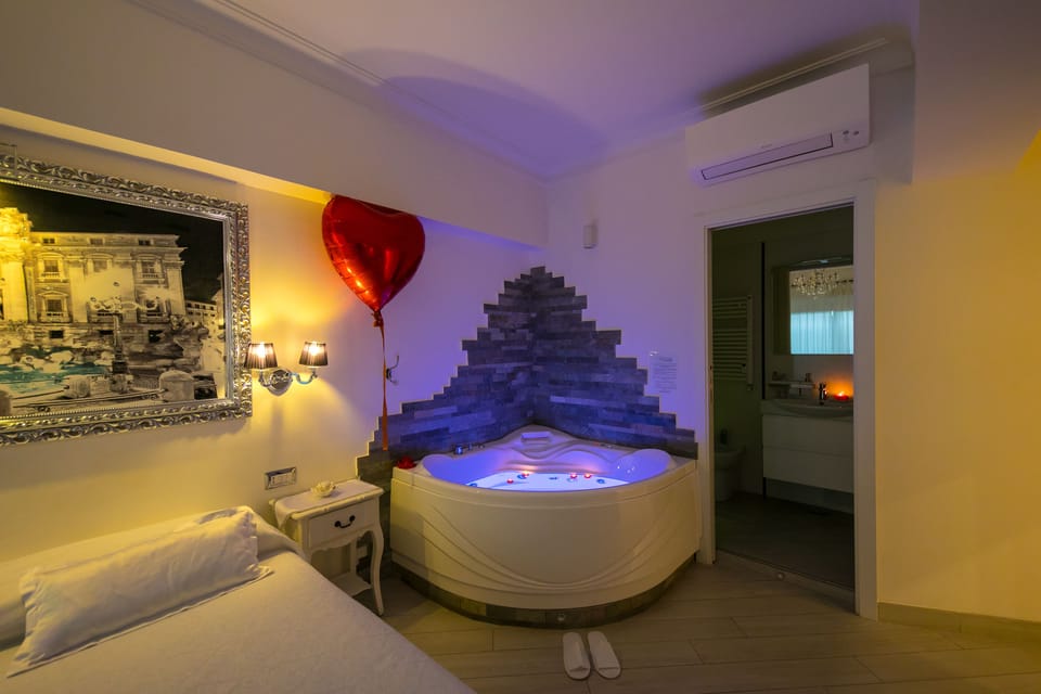 Deluxe Suite, Jetted Tub | Minibar, in-room safe, desk, soundproofing