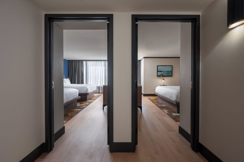 Premium bedding, desk, laptop workspace, blackout drapes