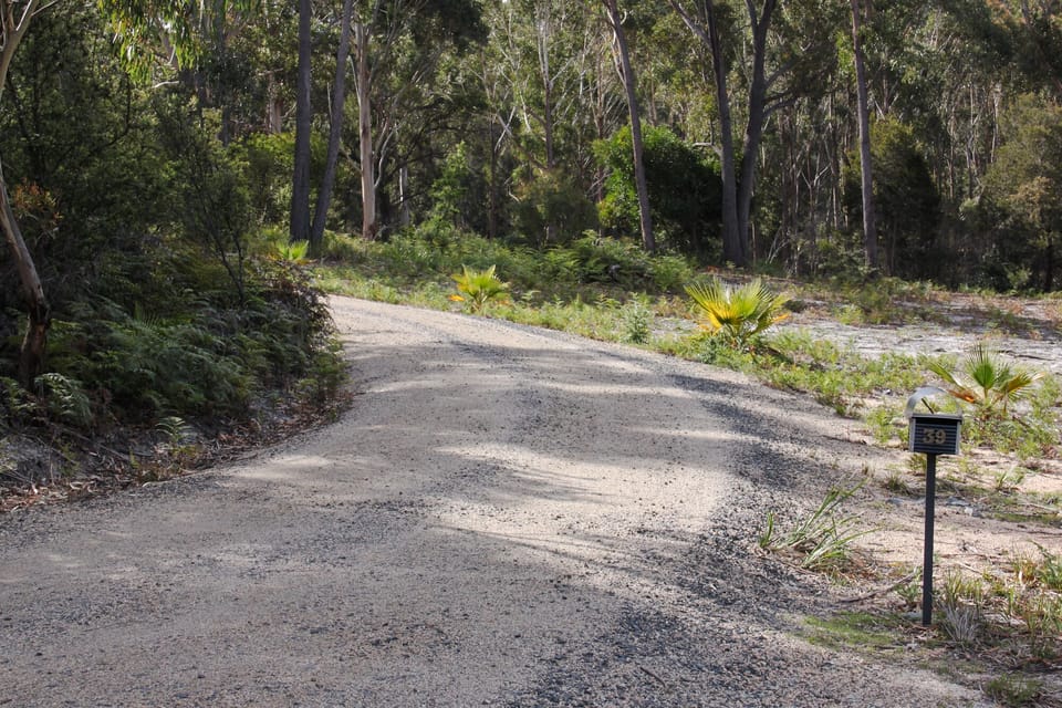 The entrance to the driveway up to the house from the road