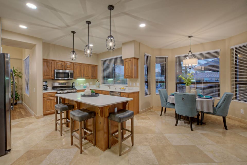 Open, spacious and naturally bright kitchen with bar and table seating options.