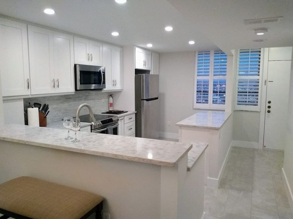 Reverse view of the kitchen, breakfast bar with stools.