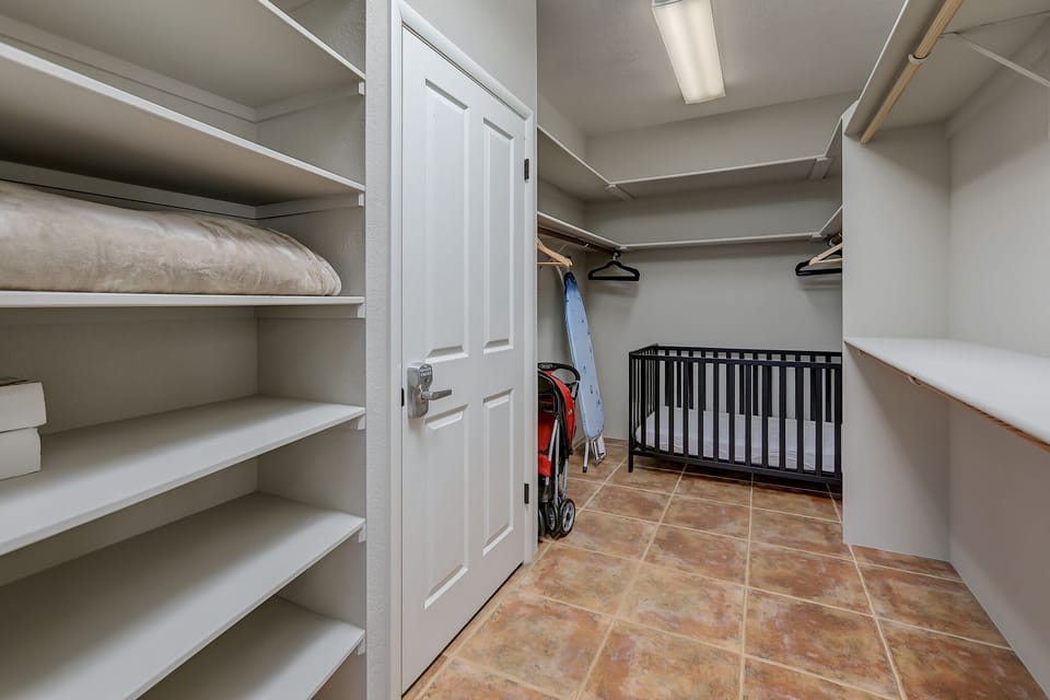 Master bedroom closet with crib.