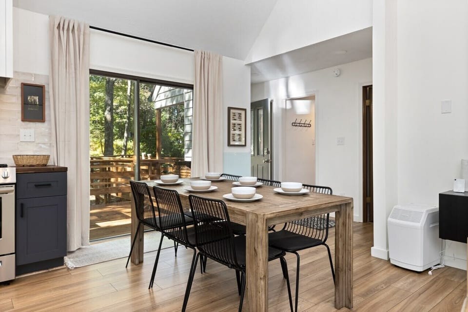 Indoor dining area opens to outdoor front porch and dining