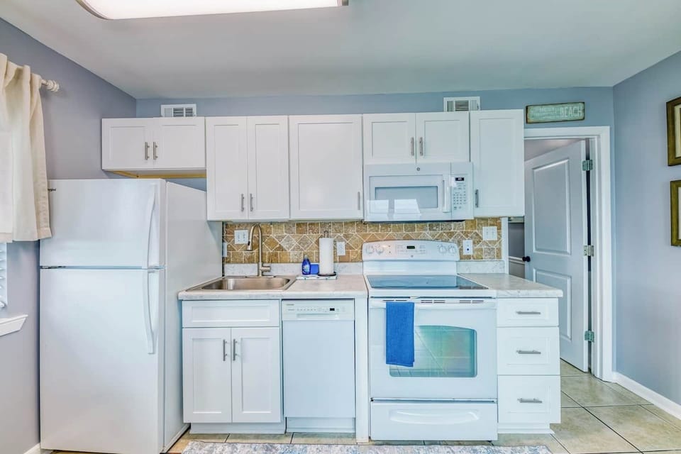 Full size refrigerator and stove. We even have a dishwasher. We do not have an ice maker. There are ice vending machines located at all of the Gulf Shores buildings.  We have lots of the kitchen items necessary to cook a meal including pots, pans, pl