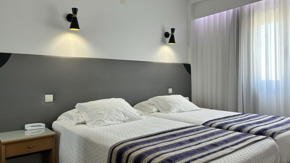 Standard Twin Room | Minibar, in-room safe, desk, soundproofing