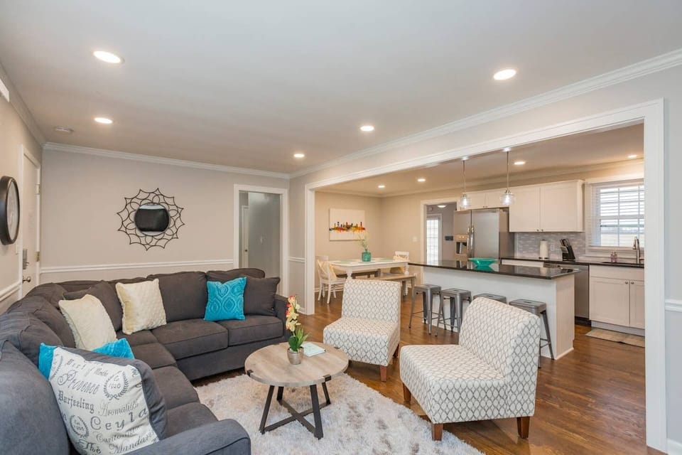 Open space living room with plenty of seating and flat screen TV.