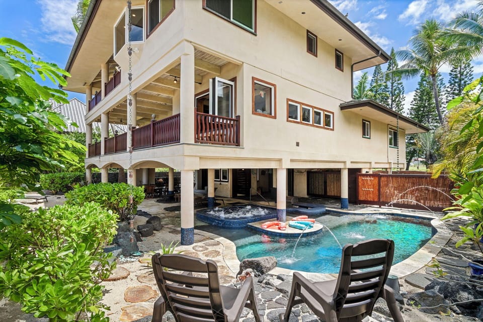 Backyard oasis with swim-up bar, spa, and covered seating—designed for endless family fun.