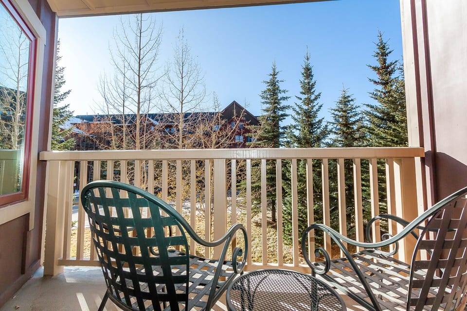 Step onto your private balcony and breathe in the crisp mountain air while enjoying peaceful forest views from your outdoor chairs.