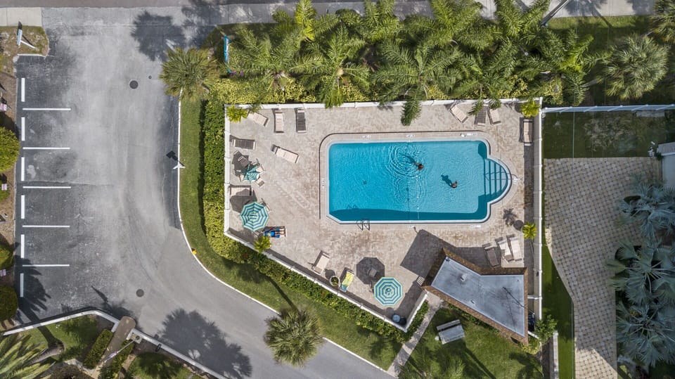 Aerial view of community pool and building complex from above