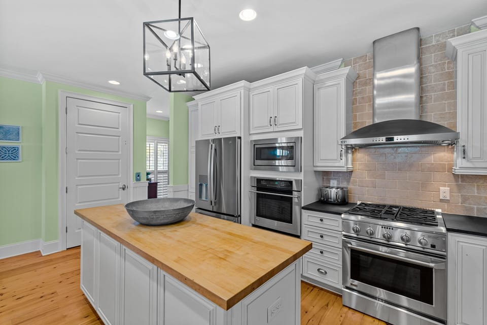 Cook memorable meals in this chef-inspired kitchen featuring stainless appliances, and a spacious island for gathering.