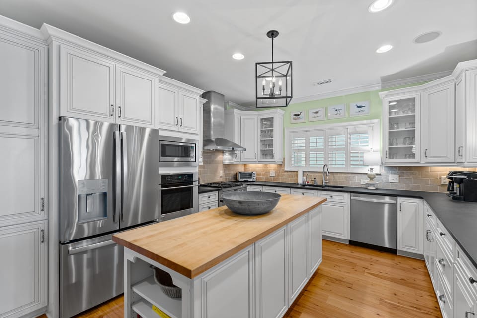 Cook memorable meals in this spacious gourmet kitchen with stainless steel appliances and warm wood island.