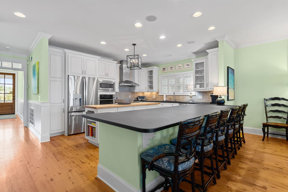 Your gourmet kitchen features spacious counters, modern appliances, and a large island with seating for memorable meals together.