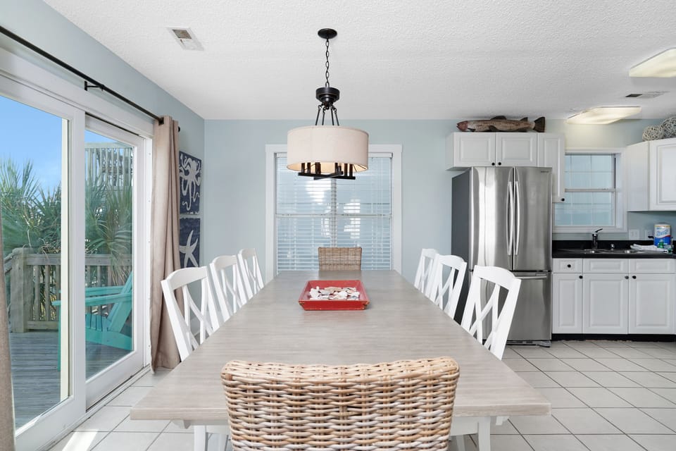 You'll love gathering around this spacious dining table with your group, bathed in natural light from large windows.