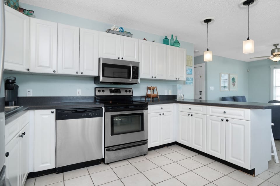 Your fully equipped kitchen features stainless appliances, granite counters, and calming coastal colors for memorable meals.