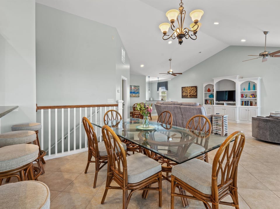 Your spacious dining area flows seamlessly into a cozy living room with built-in entertainment center and comfortable seating for memorable gatherings.