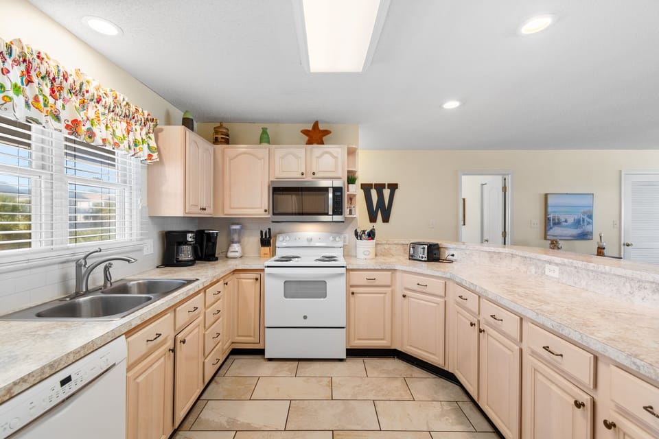 You'll love cooking in this spacious kitchen with ample counter space, modern appliances, and cheerful coastal touches that make meal prep a joy.