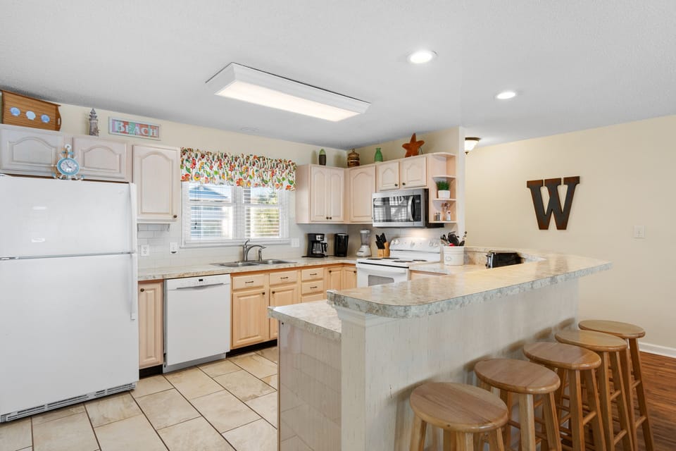 Your spacious kitchen features granite countertops, modern appliances, and breakfast bar seating—perfect for preparing meals and gathering together.
