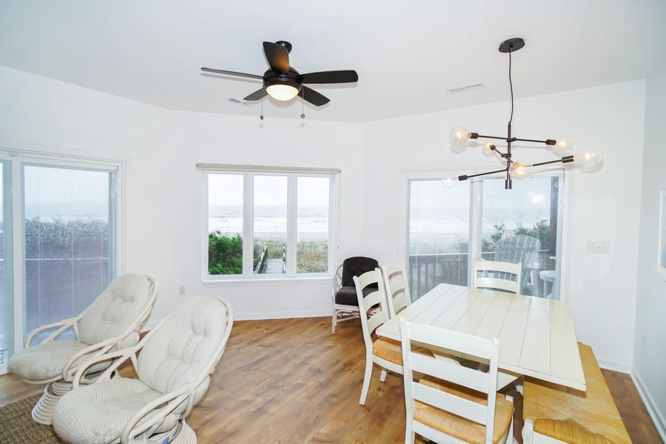 Your bright dining space features comfortable seating and stunning windows that frame peaceful views, perfect for memorable meals together.
