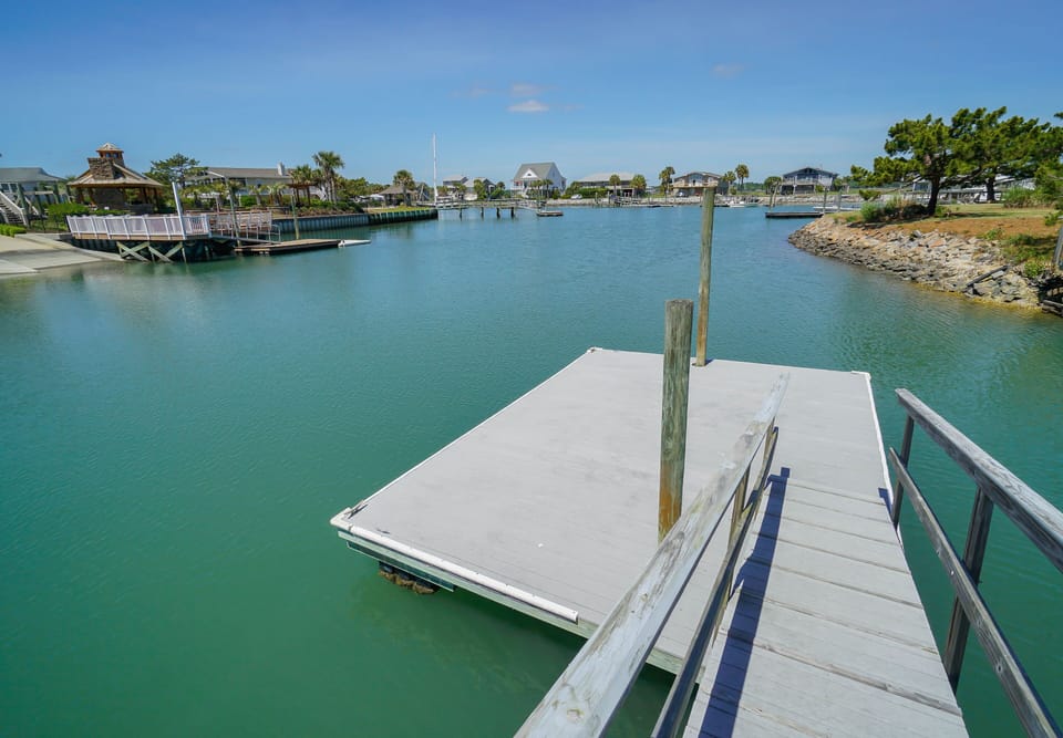 Your private dock awaits on turquoise canal waters, perfect for launching kayaks or watching sunset reflections.
