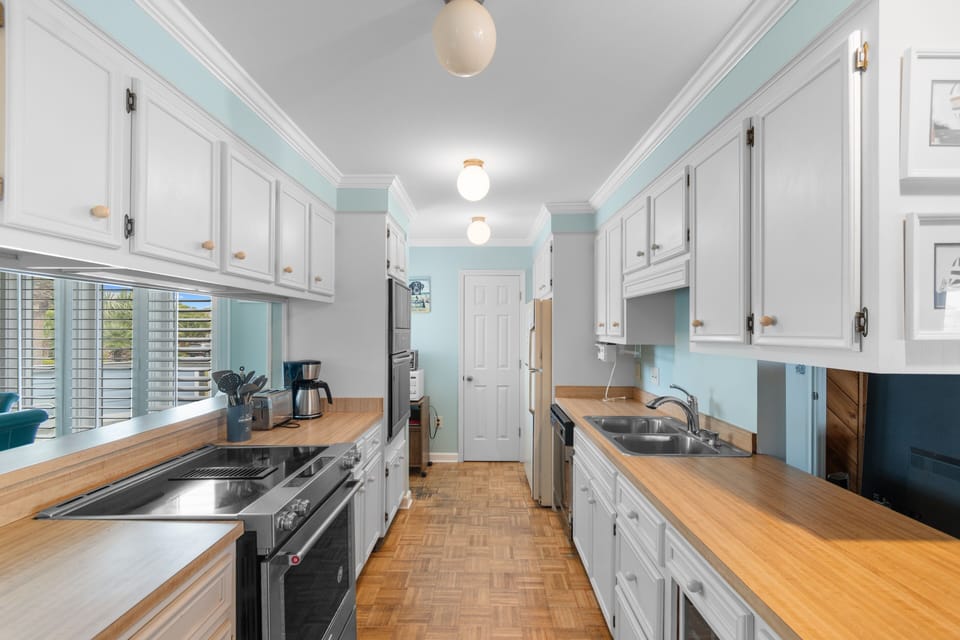 Cook together in your spacious galley kitchen, complete with warm wood countertops and modern appliances for memorable meal prep.