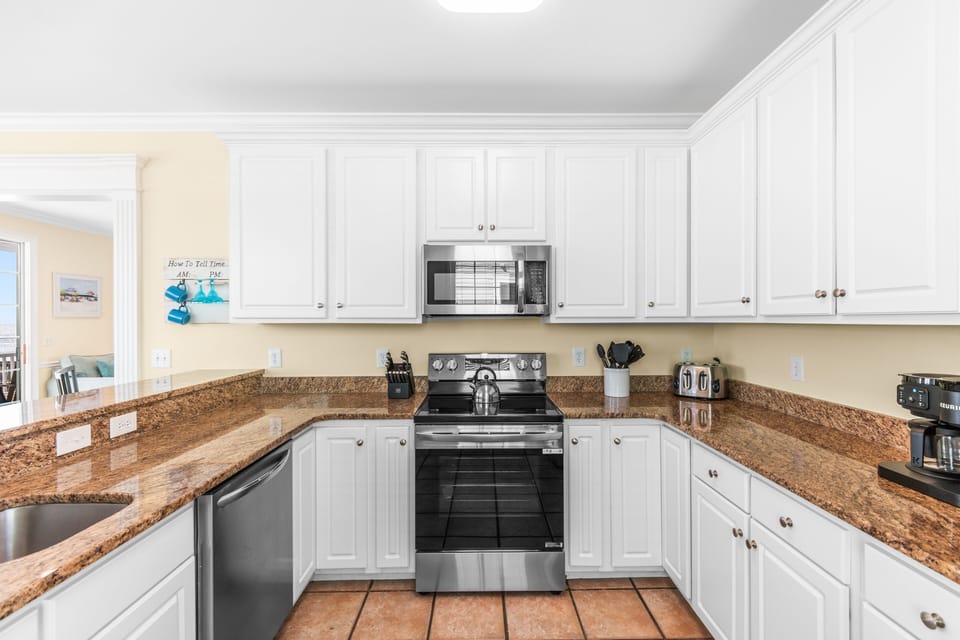 Your spacious kitchen awaits with granite countertops, stainless appliances, and everything you need to create memorable meals during your stay.