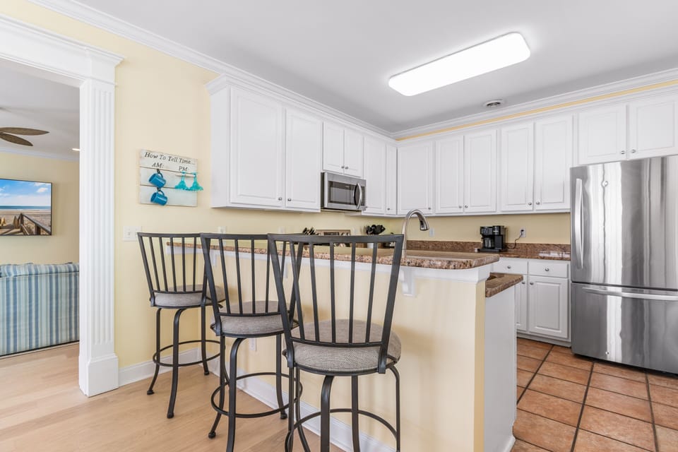 Your spacious kitchen features granite counters, stainless appliances, and a breakfast bar perfect for morning coffee together.