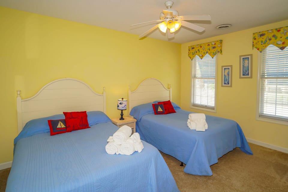 Rest peacefully in your cheerful bedroom, where sunny yellow walls and nautical touches create the perfect coastal retreat for you.