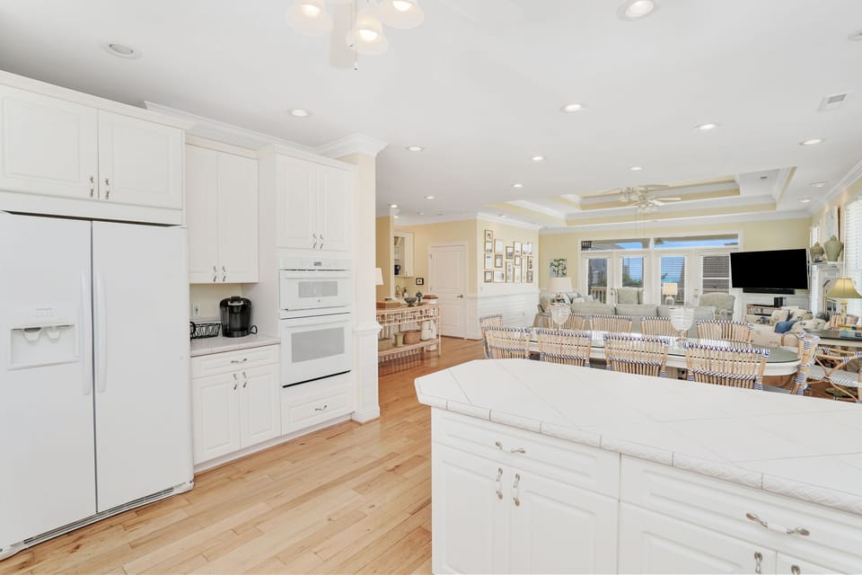 Bright open kitchen with white cabinets flows seamlessly into your dining and living space, perfect for gathering with loved ones.