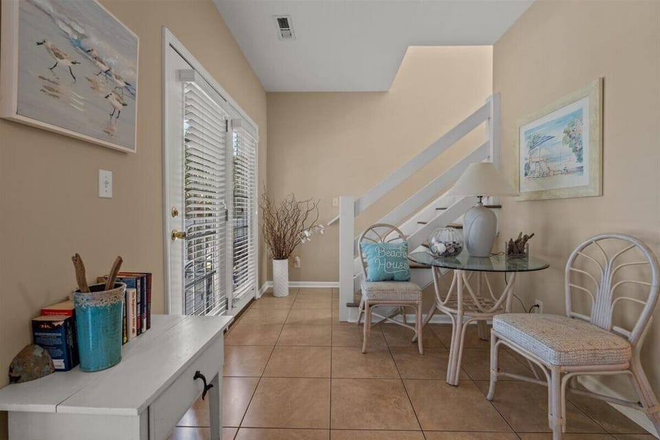 Your cozy dining nook features beachy touches and warm natural light, perfect for morning coffee or planning your day's adventures.