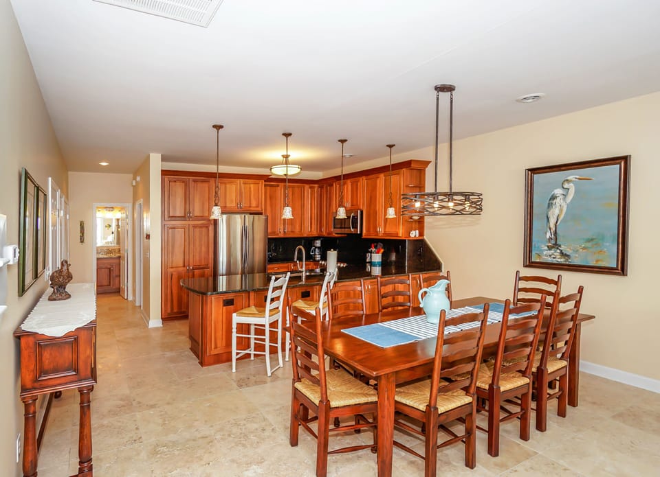 Gather around your spacious dining table for memorable meals while the gourmet kitchen invites culinary adventures with rich wood cabinetry and modern appliances.