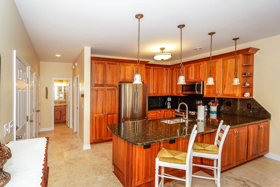 Your gourmet kitchen awaits with rich cherry cabinets, granite counters, and stainless steel appliances—perfect for creating memorable meals together.